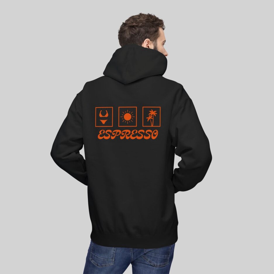 Person wearing a black Sabrina Carpenter Espresso Vibes Hoodie with orange graphics and 'Espresso' text on the back against a gray background
