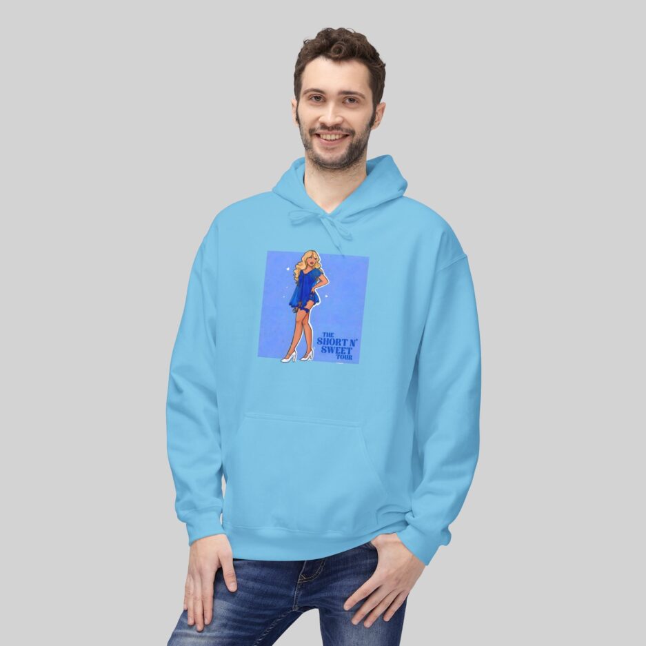 Person wearing a light blue Sabrina Carpenter Short N' Sweet Tour Hoodie with a graphic design on a plain background